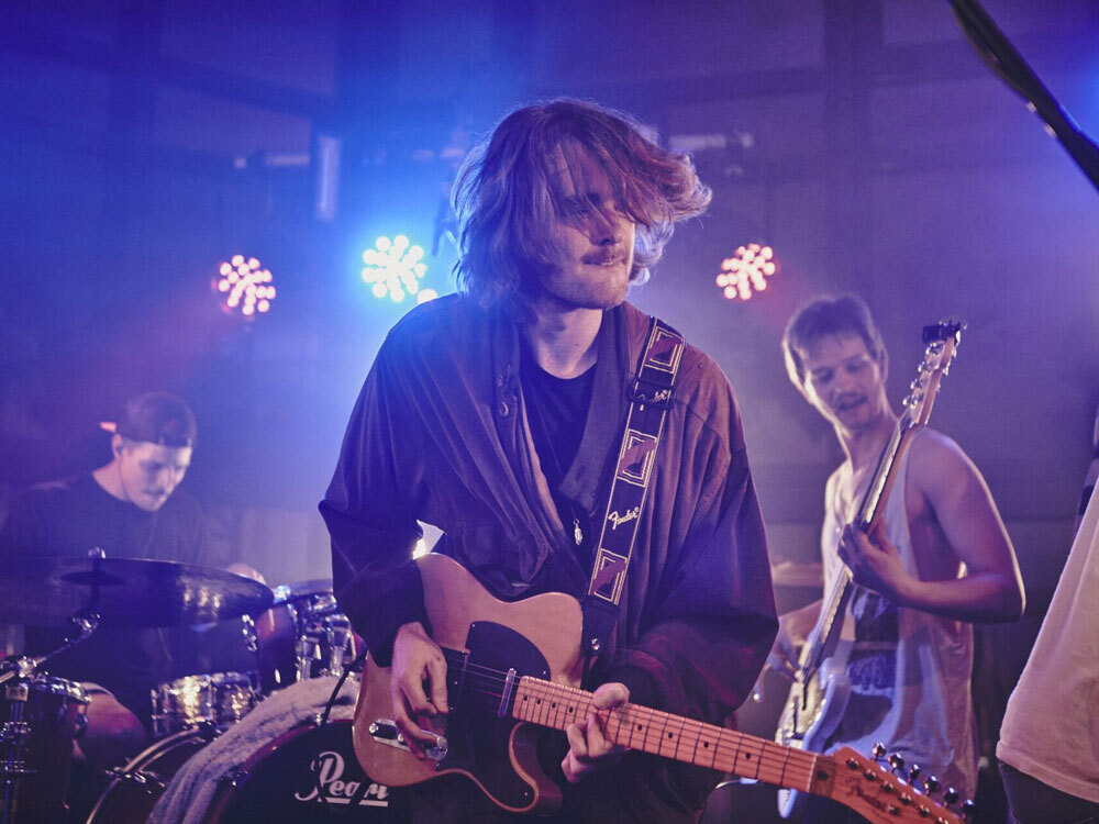 Man with guitar on stage